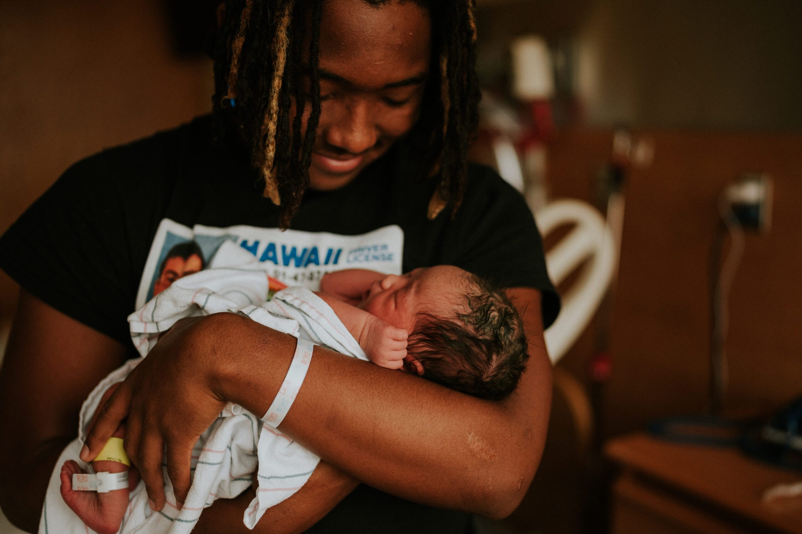New Father holding baby in the hospital