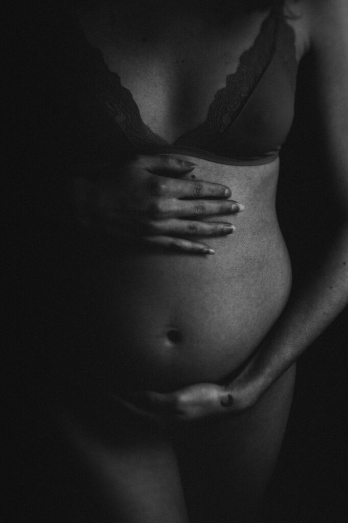 moody maternity portrait of baby belly