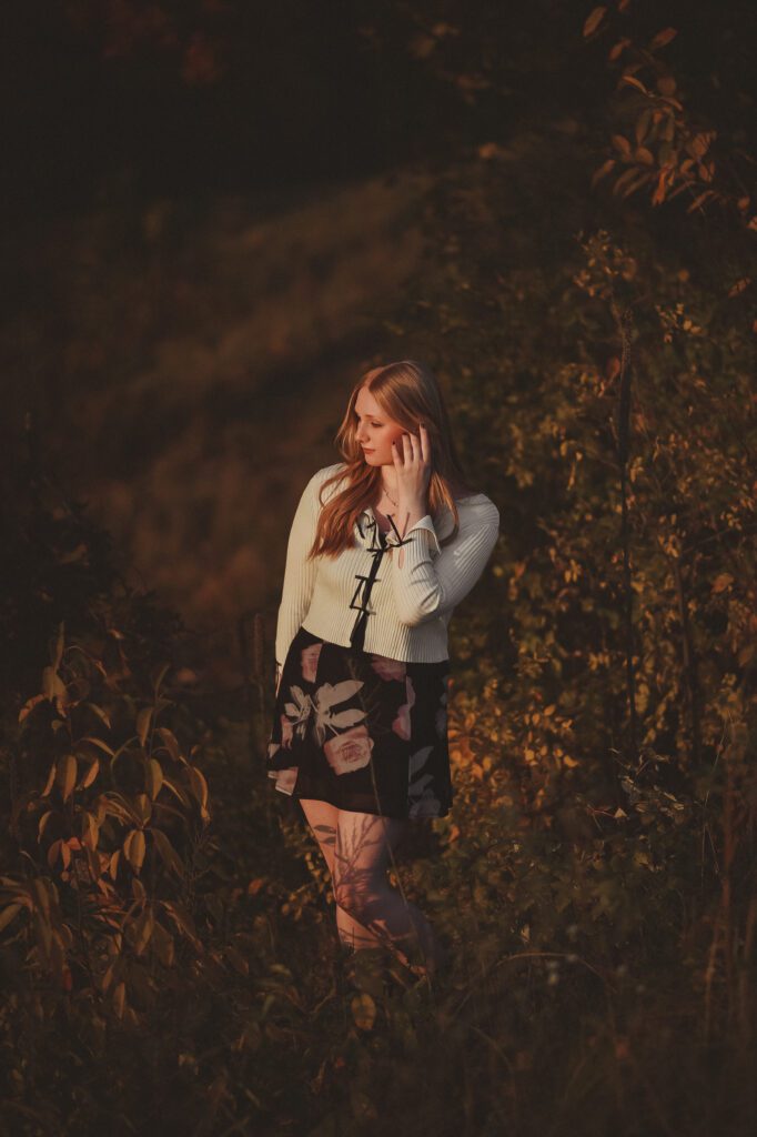 Female Champlin Park high school senior in a nature reserve showing us how that golden light compliments the whole scene