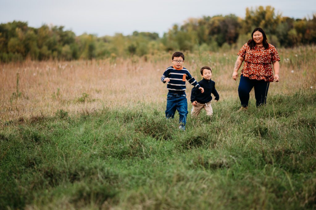 Single mom playing in a field with her two boys in Champlin, MN
