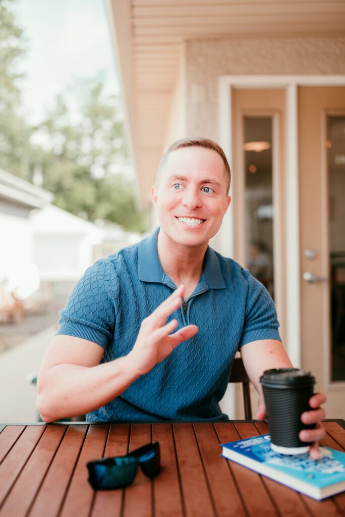 Brandon smiling during a coffee shop date, showing personality and openness.